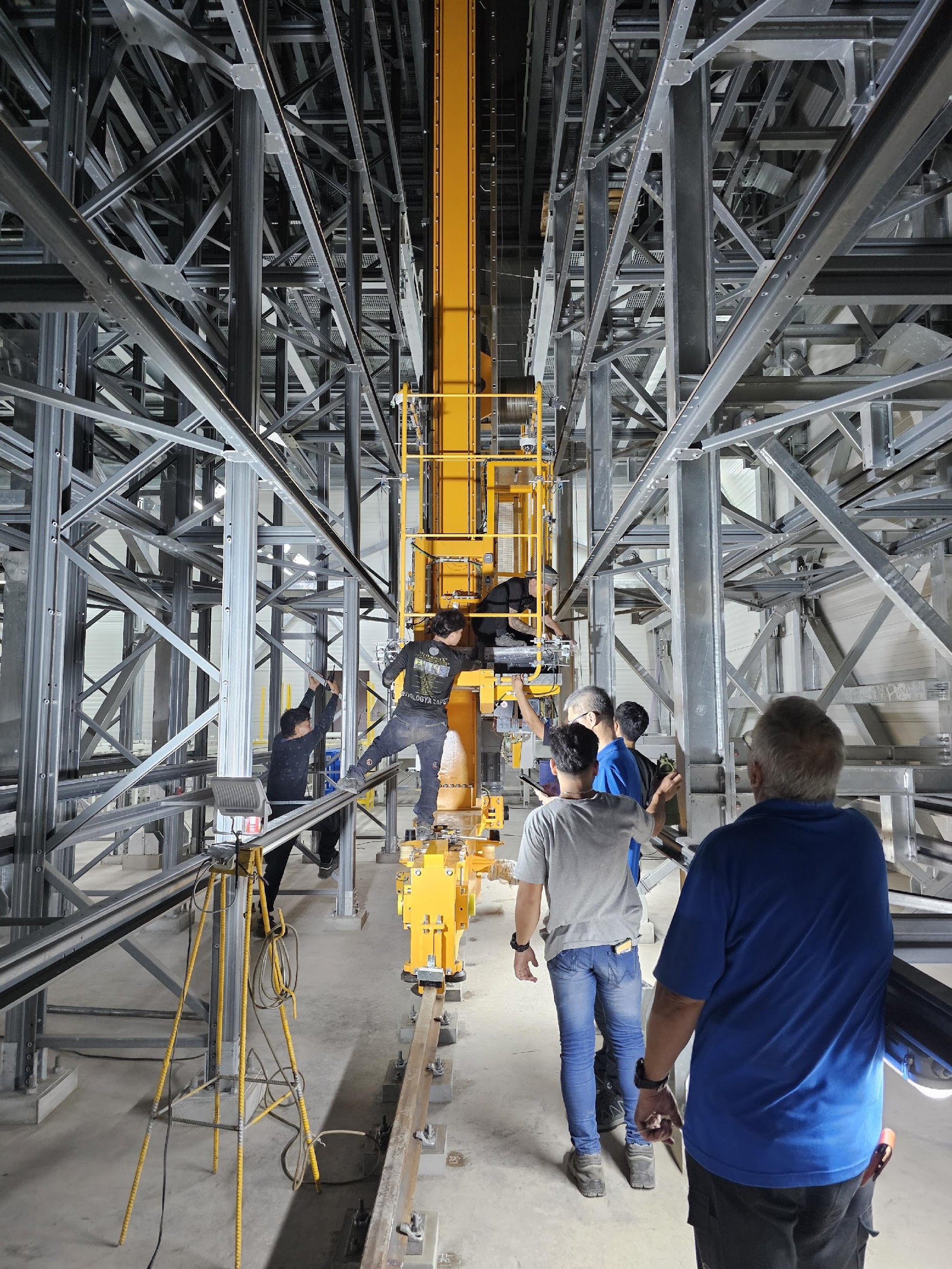Stacker crane installation inside ASRS rack aisles
